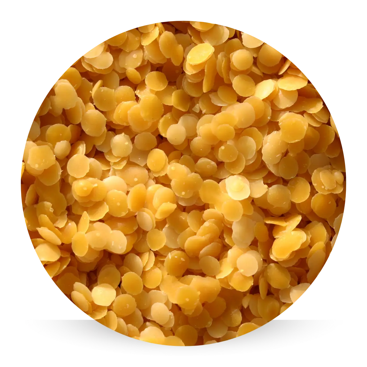 Golden beeswax pellets, known for sealing in moisture and forming a protective barrier to keep skin soft, smooth, and hydrated all day.