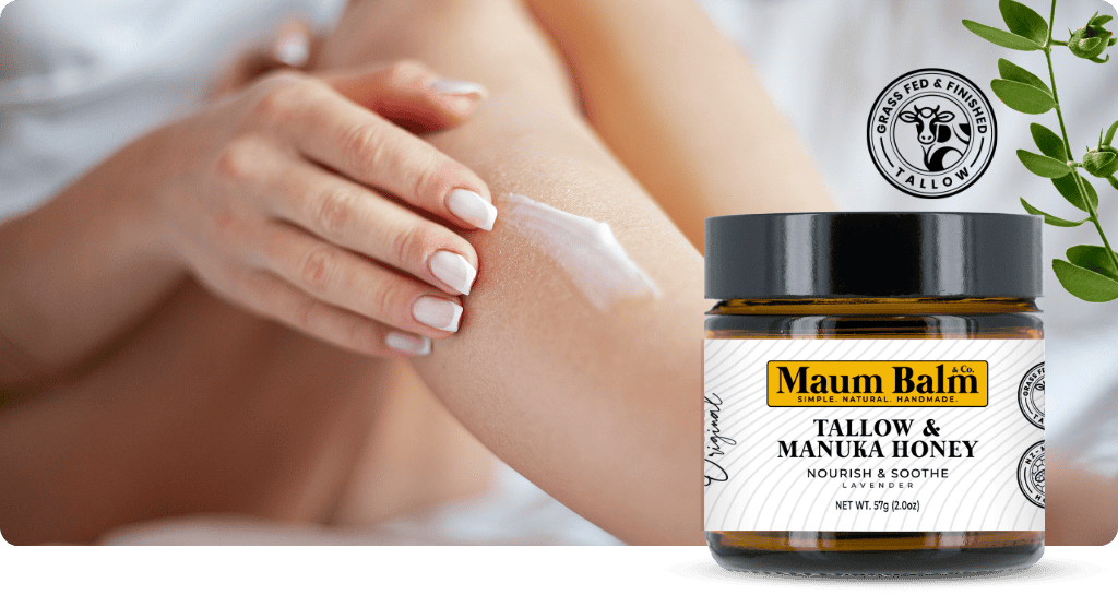 Woman applying Maum Balm Tallow & Manuka Honey to her arm for deep hydration and skin nourishment, with a jar of Maum Balm in the foreground.